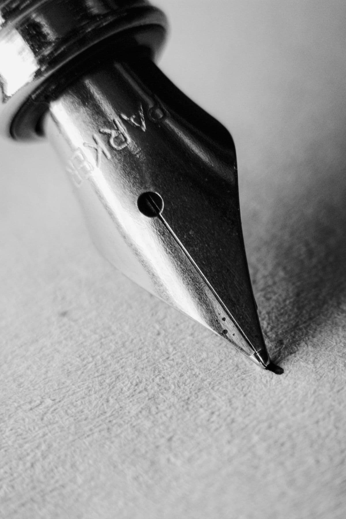 A fountain pen nib resting on paper